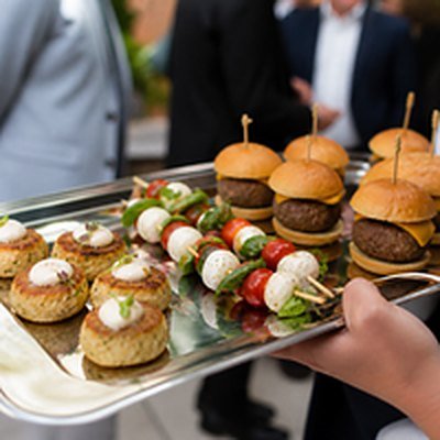 Passed appetizers including sliders, caprese skewers and mini crab cakes